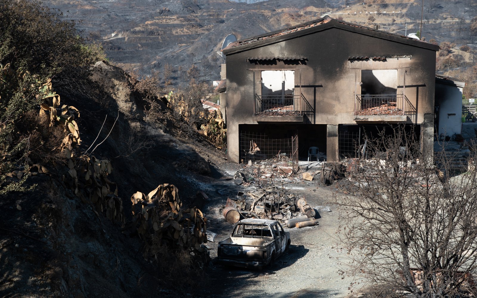 A house burned to its frame in a wildfire