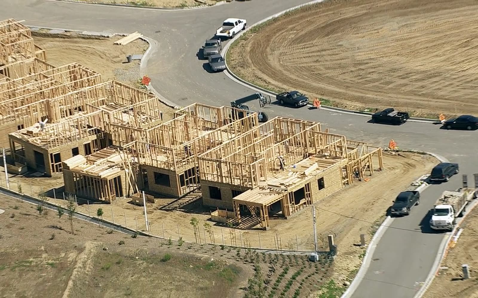 Custom homes at the framing stage from the air